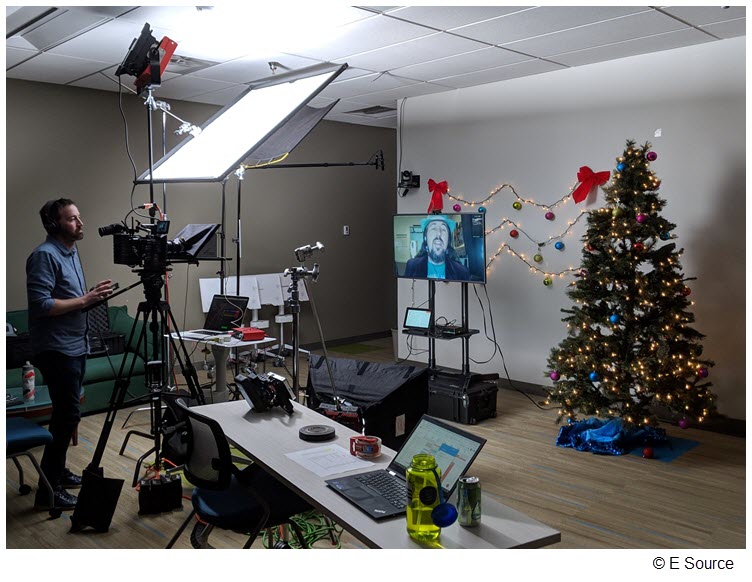 Still image of the set of the E Source holiday card, with remote employee Bryan Jungers on the screen