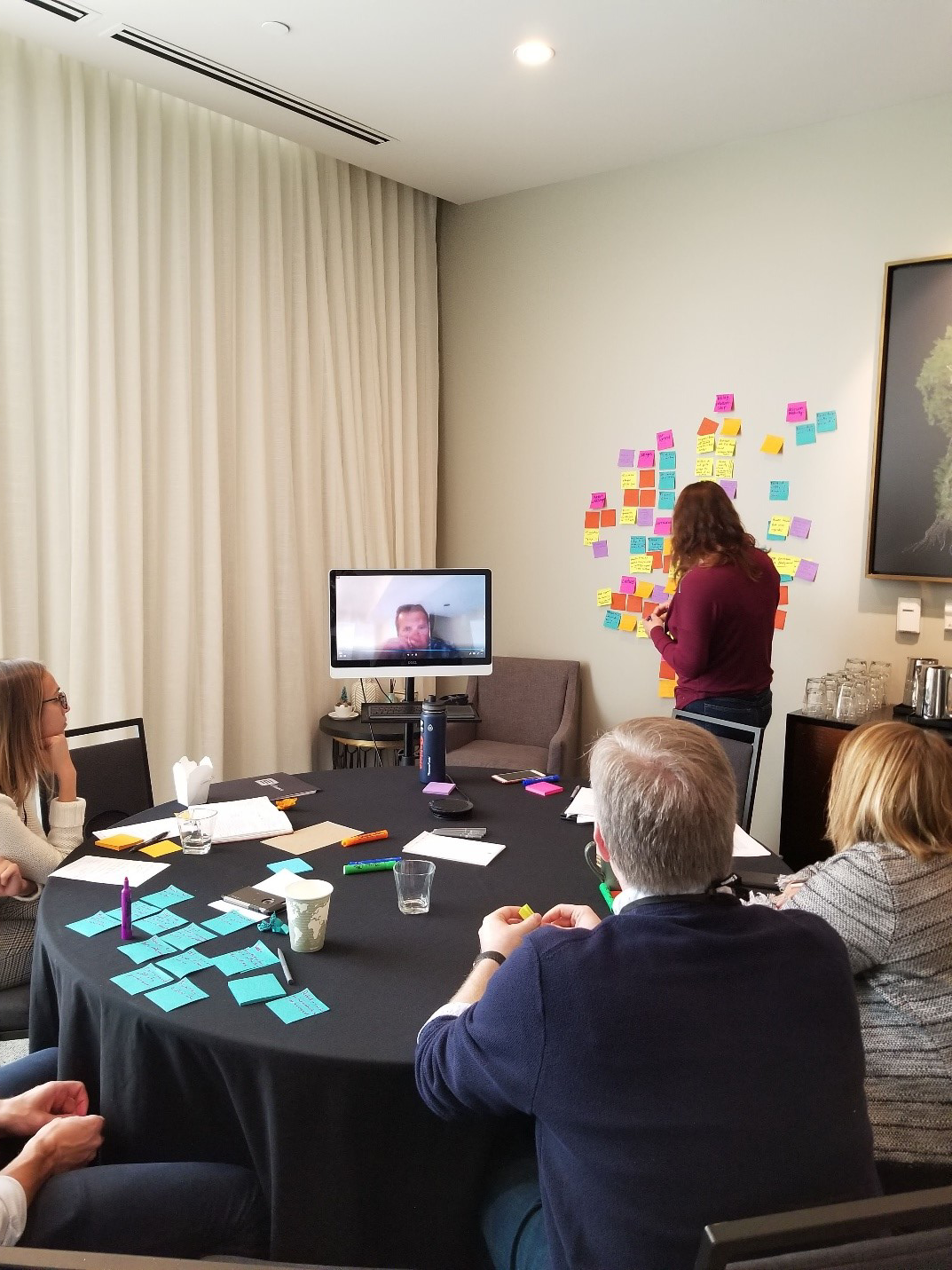 E Design attendees make notes while watching ethnographic research video clips