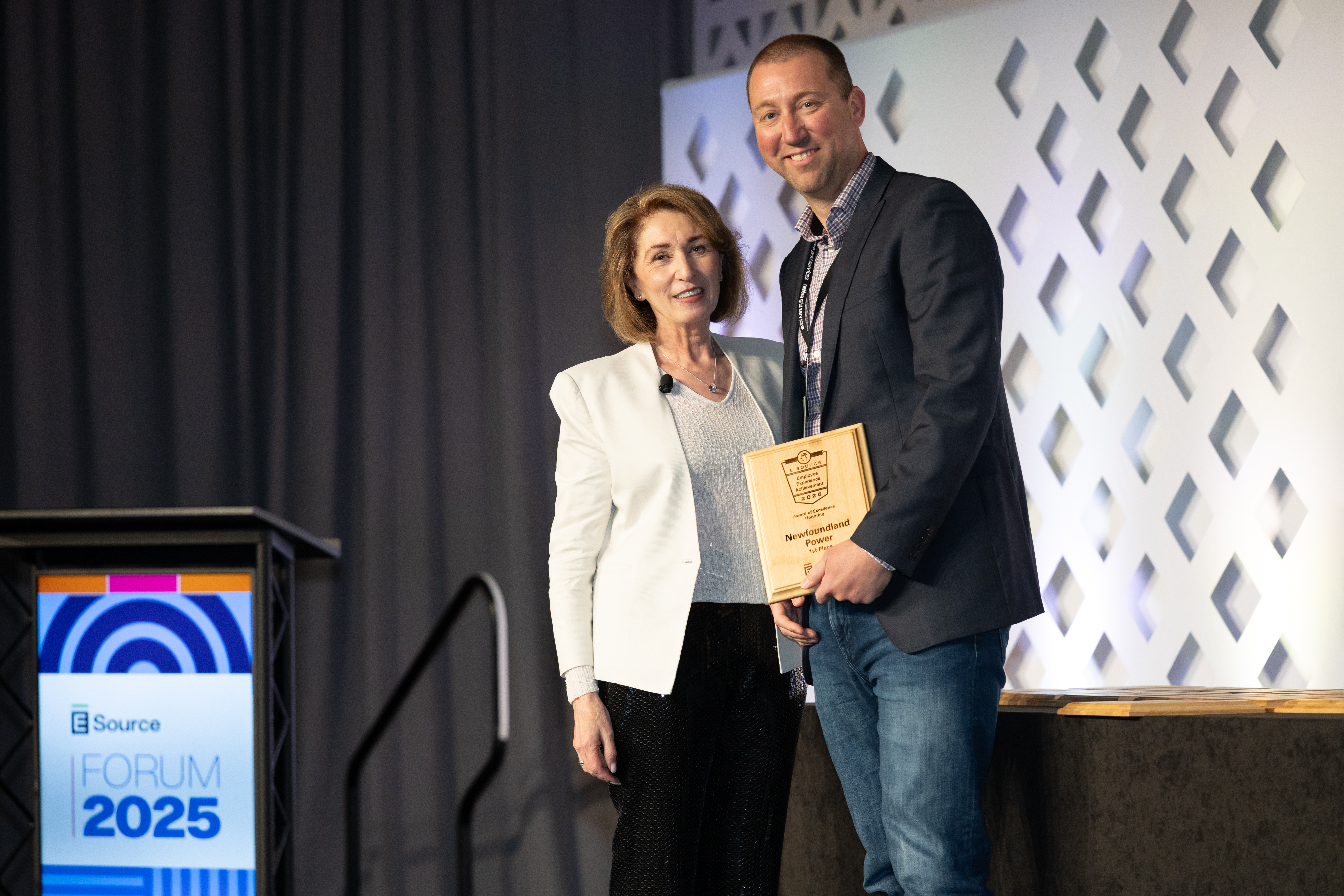 Attendee accepting the award for Achievement in Employee experience at Forum.